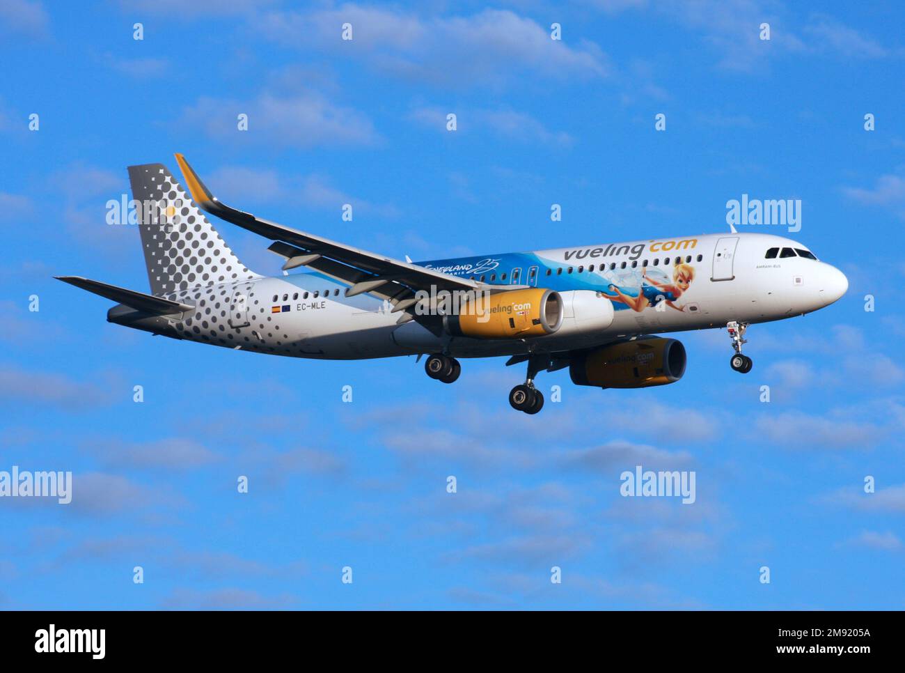 An Airbus A320 of Vueling with 25 Years of Disneyland Paris scheme lands at London Gatwick Airport Stock Photo
