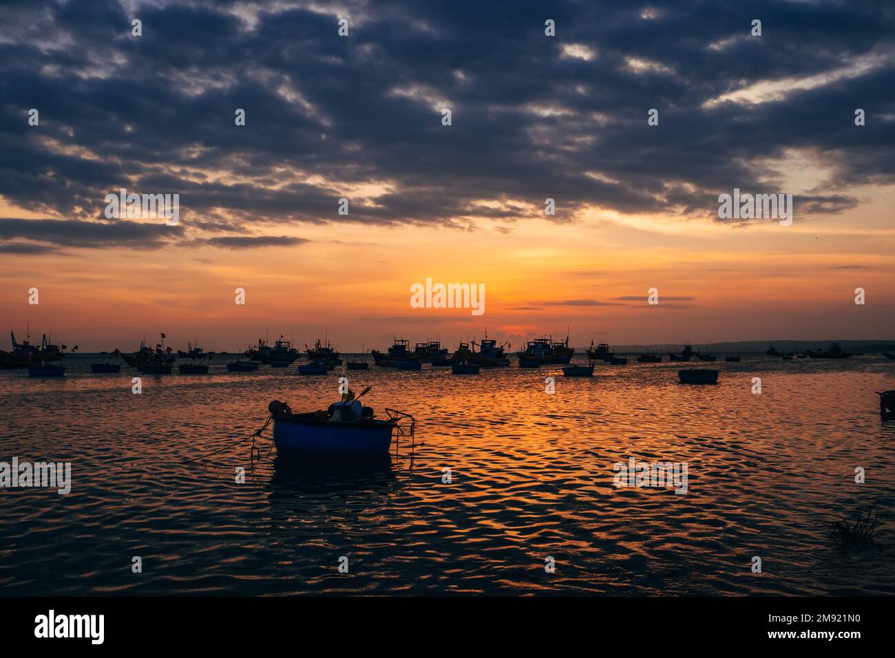 Colorful sunset ocean silhouettes boats hi-res stock photography and ...