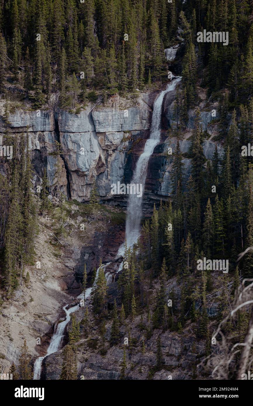 A vertical shot of the waterfall in the mountains Stock Photo - Alamy