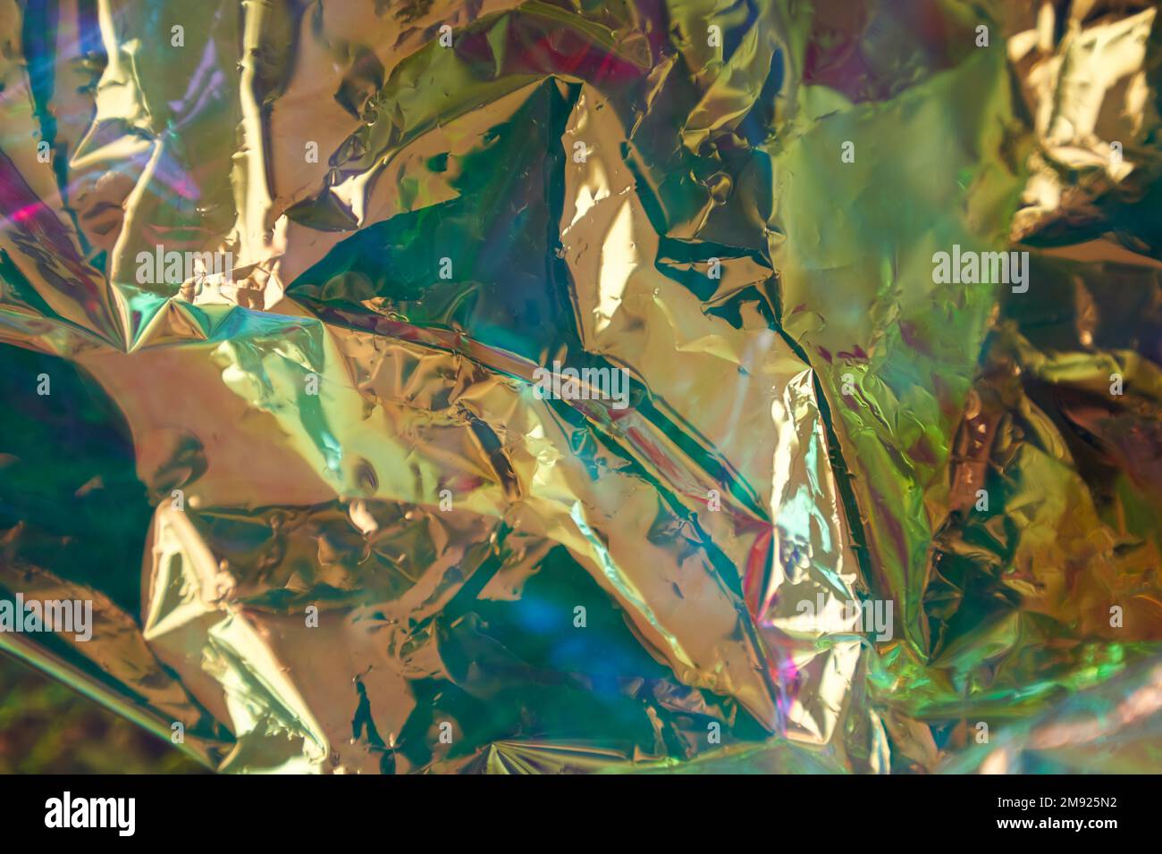 Foil with a metallic effect of green-blue shades. Multicolored texture. Bright colored background. Abstract colors. Multicolor pattern for design background, prints. High quality photo Stock Photo