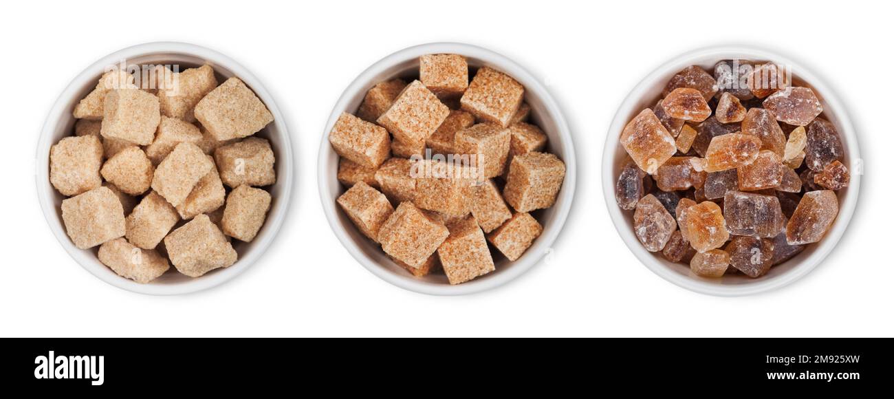 Bowl plates of natural brown unrefined and caramelized sugar cubes on