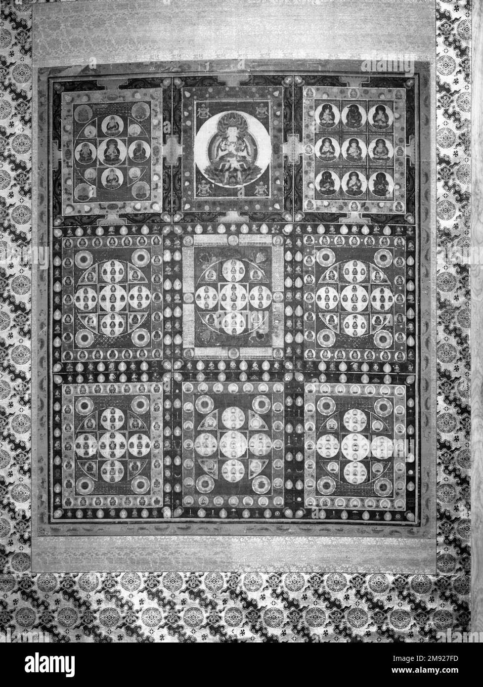 Kongō-kai Mandara Kongō-kai Mandara, 14th century. Opaque watercolor, ink and gold on silk, overall: 84 × 47 3/8 in. (213.4 × 120.3 cm).  The mandala (or mandara in Japanese) is a diagrammatic tool used by Buddhists to guide their meditation and prayer. Most mandalas direct the viewer to travel mentally on a prescribed path, stopping to contemplate and address each figure depicted. In this early Diamond World (Kongō-kai) mandala, the primary deity, Dainichi Buddha, is in the top section; in most other mandalas the primary deity appears at the center. The mate to this painting is displayed in t Stock Photo