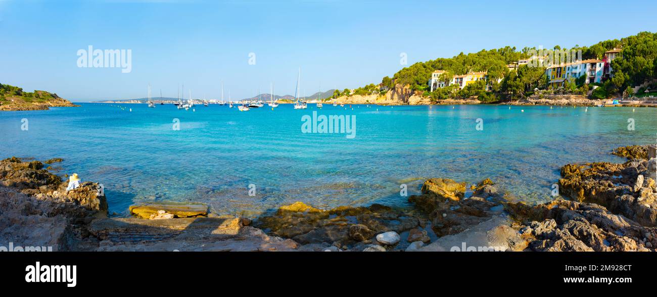 Panoramic of the Xinxell cove, with anchored sailboats, apartments and Palmanova in the background, in Mallorca, Spain Stock Photo