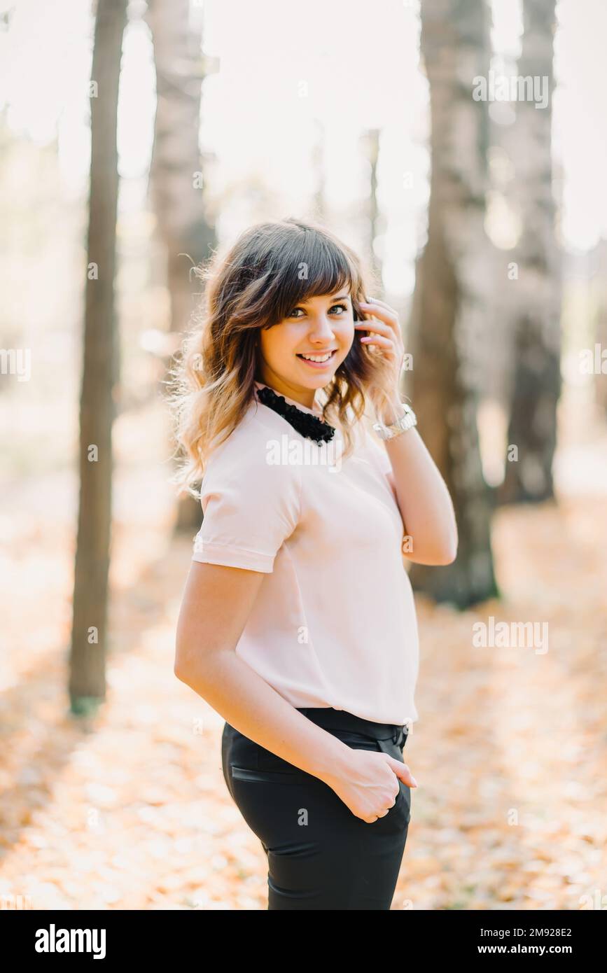 portrait of brunette girl Caucasian appearance smiling in Park in autumn Stock Photo