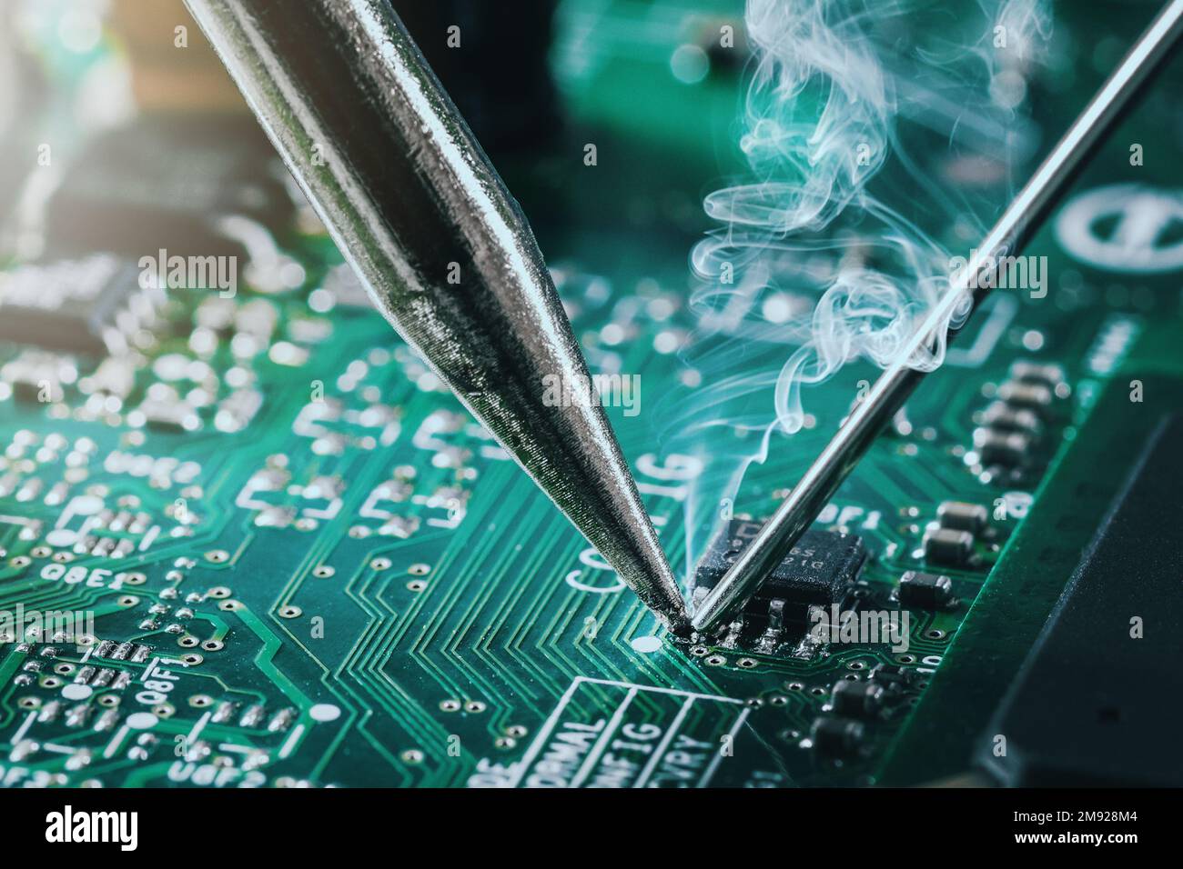 soldering iron solder the computer chip on circuit board. closeup Stock