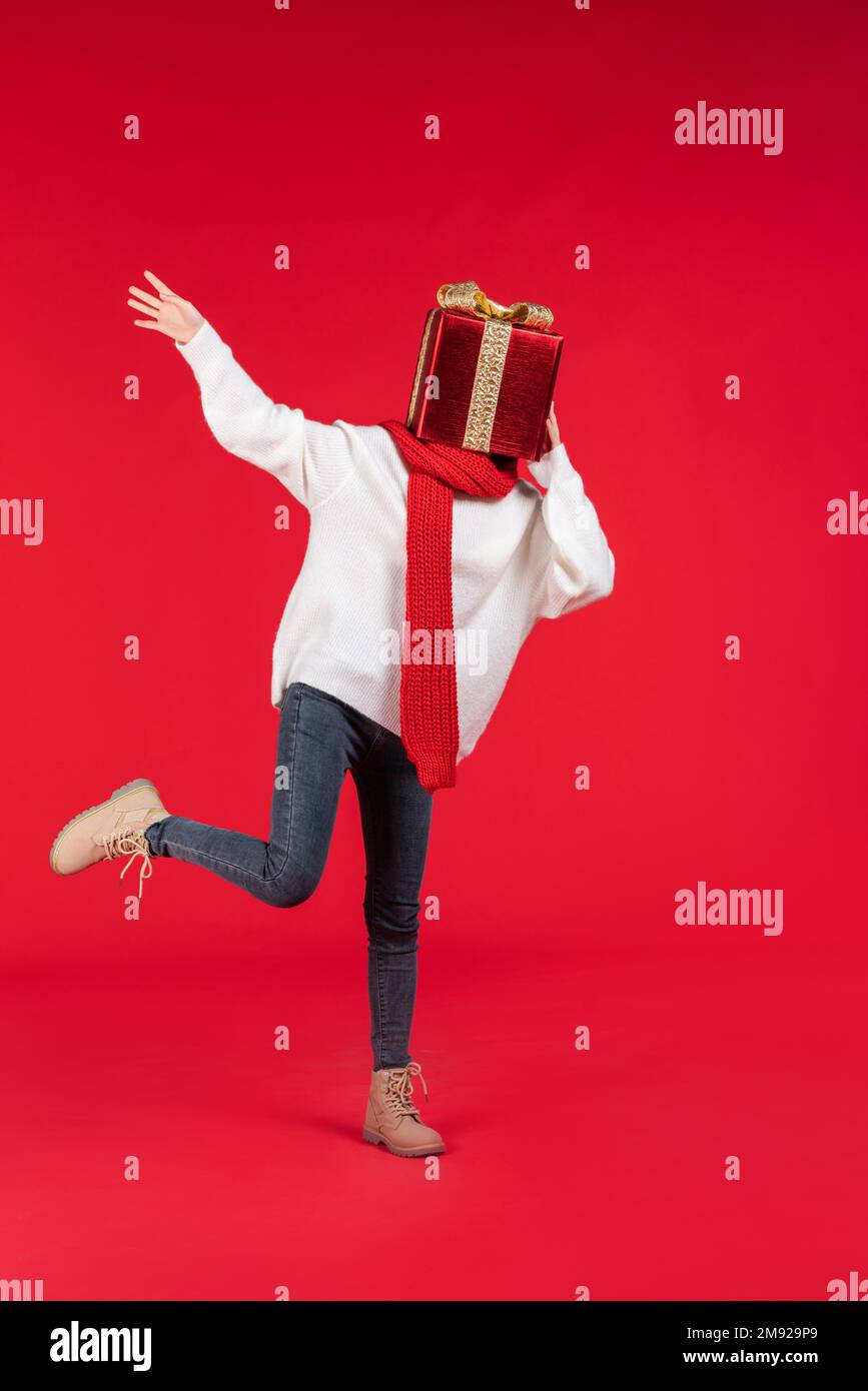 Happy young woman holding a gift Stock Photo - Alamy