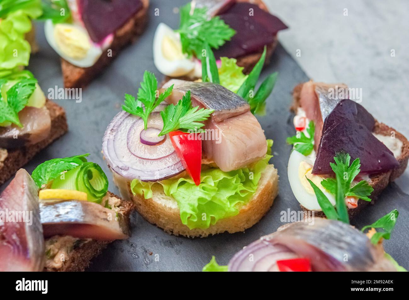Appetizer with salted herring, pate, onion, egg, lettuce, tomato and beetroot. Scandinavian