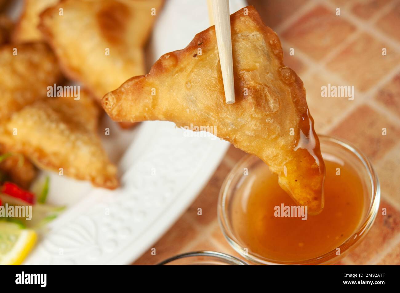 Chinese wontons with sweet chilli dip sauce and chop sticks Asian fried dumplings with soy sauce