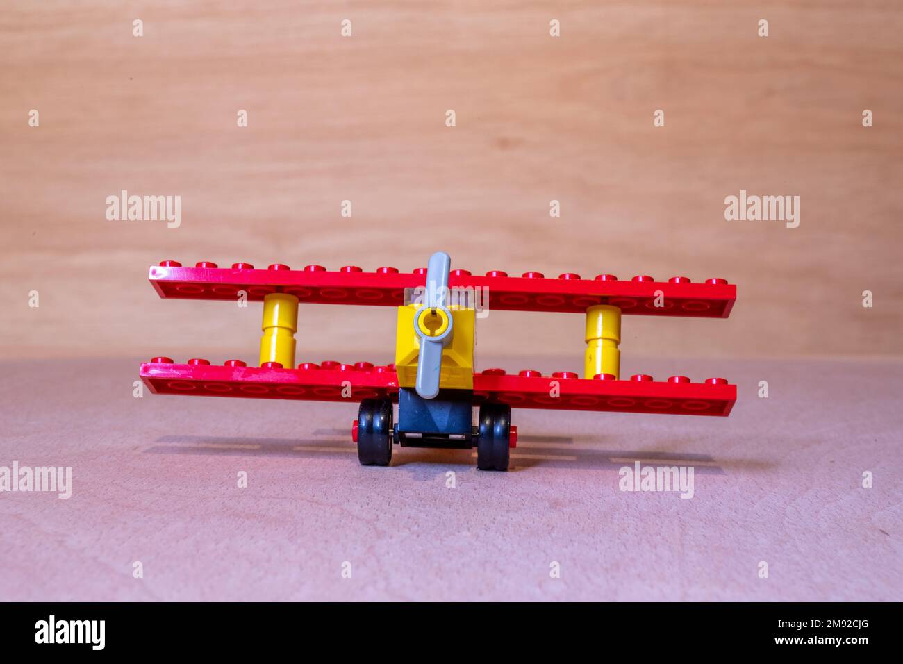 A closeup shot of the Vintage Lego kit 613 a bi-plane from 1974 on a wooden background Stock Photo