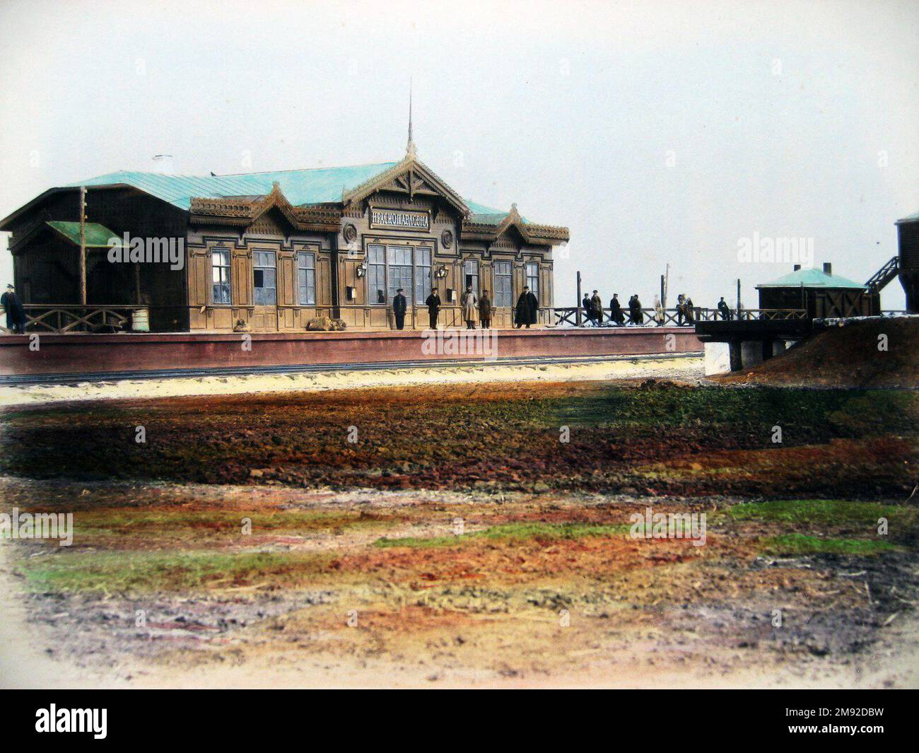 People watiing for a train at a station along the route of the Kursk ...