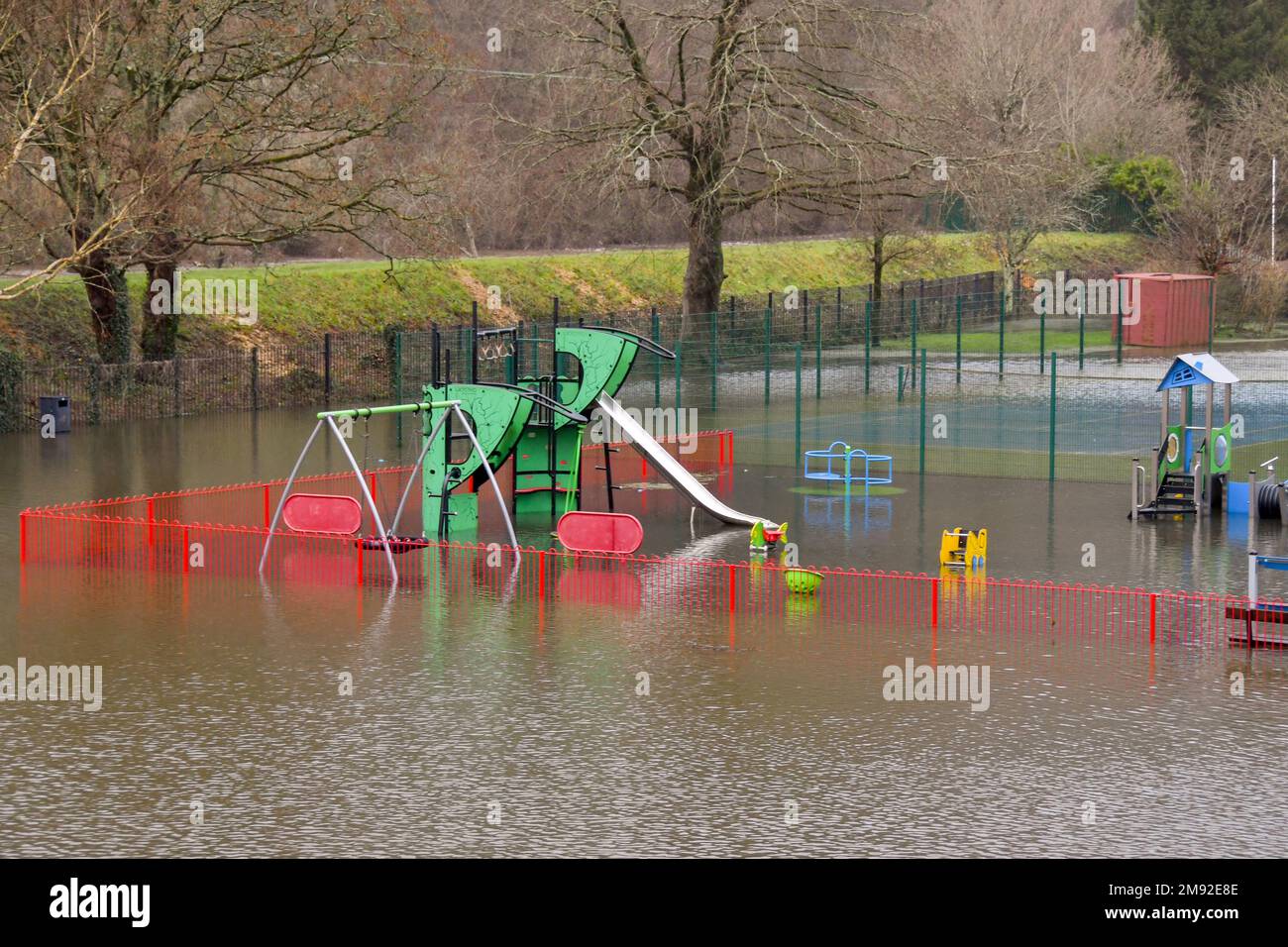 Taffs Well, Cardiff, Wales - January 2023: Children's playground in the village underwater after flooding from the River Taff Stock Photo