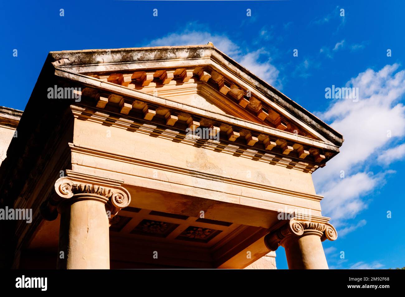 A portico with columns and a triangular pediment on the Greek-style ...