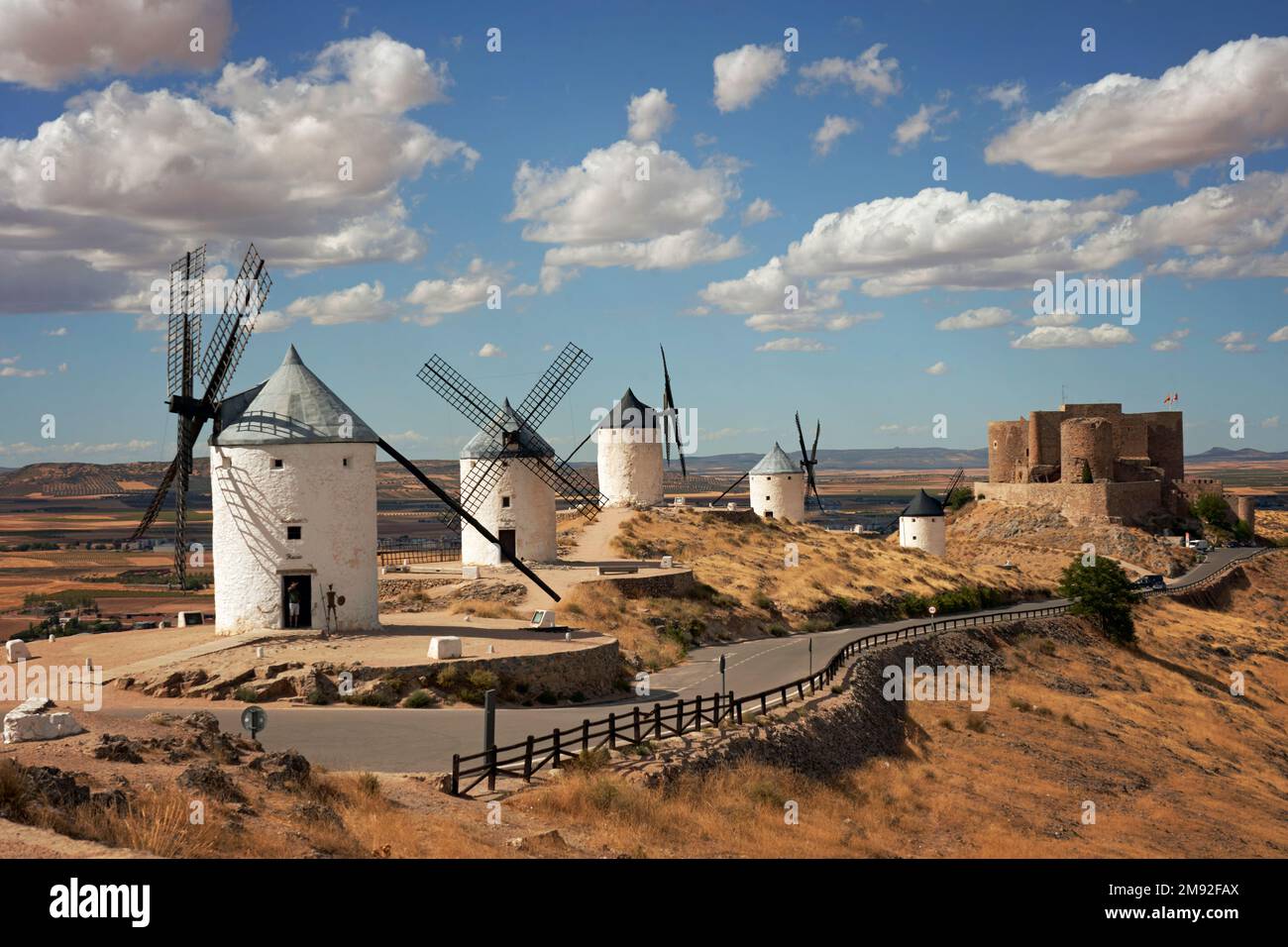 Consuegra Windmill And Castile La Mancha With The Winding Road In The consuegra-windmill-and-castile-la-mancha-with-the-winding-road-in-the