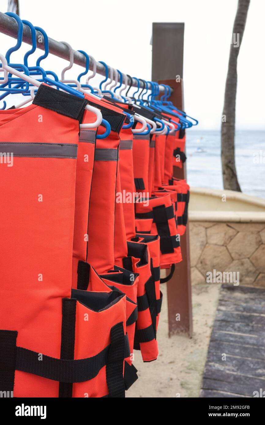Life jackets dry on hangers at a beach, selective focus Stock Photo - Alamy