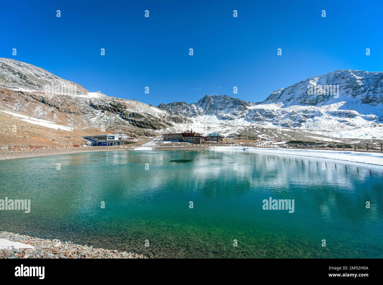 Madritschhuette and water reservoir overlooking the mountains on a sunny autumn day Stock Photo