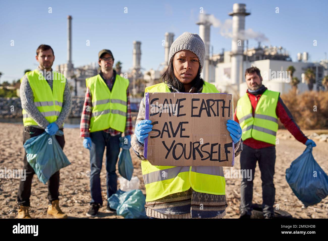 Protester young latin activist looking at camera holding a banner Stock Photo