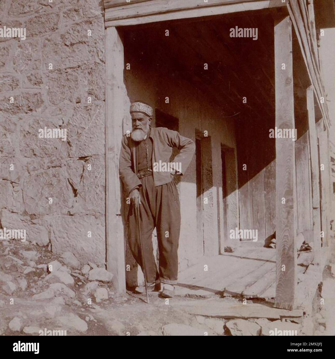 Village Nikita, Crimea. old man standing next to building ca. 1905 Stock Photo