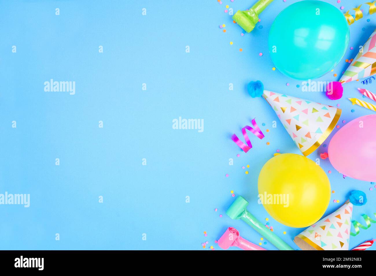 Party background with balloons, streamers and confetti on pastel blue  background. Birthday party decoration Stock Photo - Alamy
