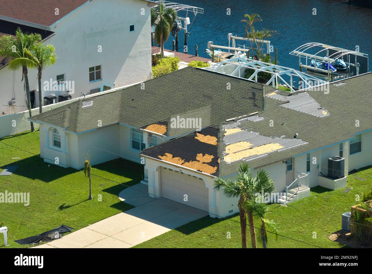 Hurricane Ian destroyed house roof in Florida residential area. Natural ...