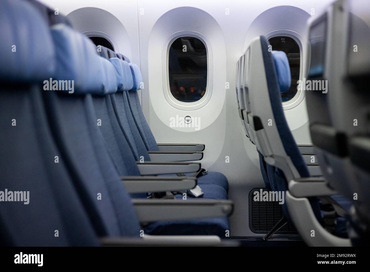 Interior of modern aircraft cabin with comfortable seats and windows in ...