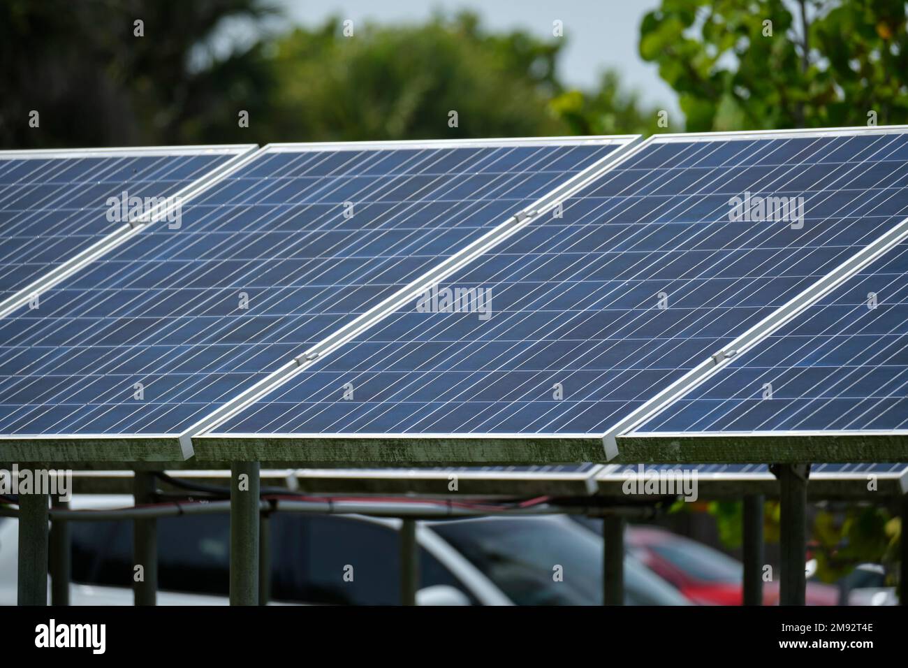 Solar panels installed on stand frame near parking lot for effective