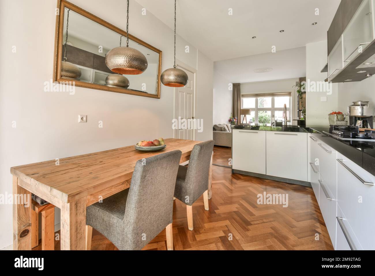 Open plan kitchen with modern appliances and dining table near living ...