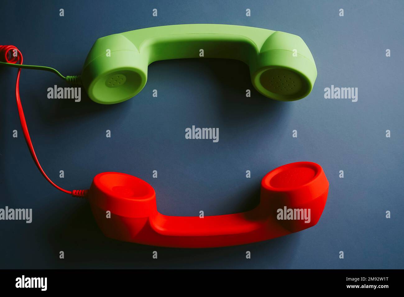 Top view of retro telephone handsets placed on gray background Stock Photo