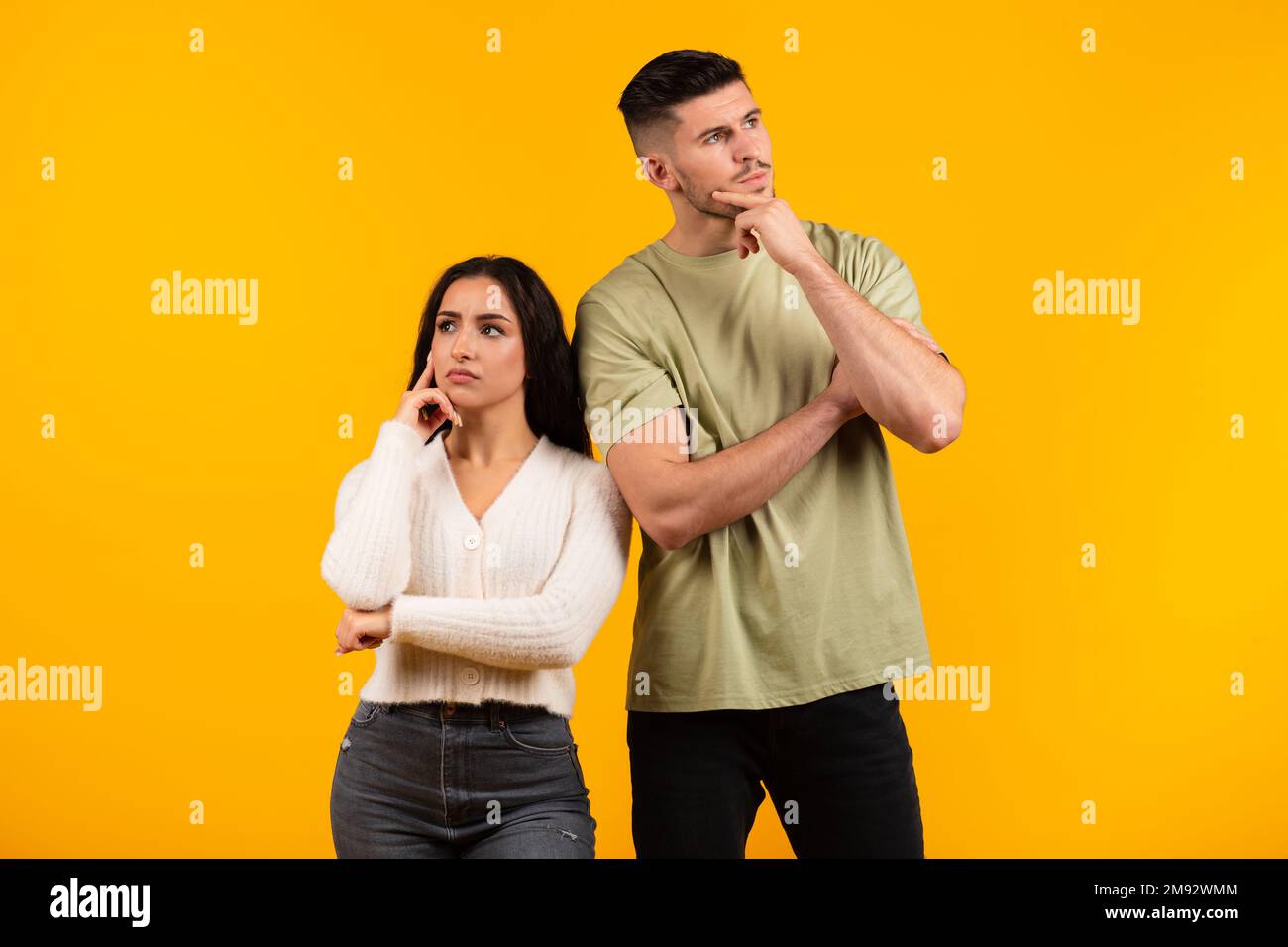 Pensive millennial middle eastern husband and wife thinking, look in ...