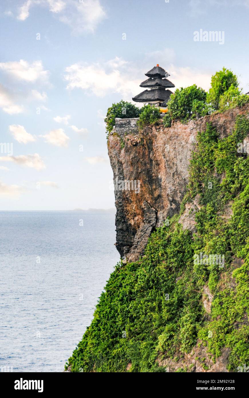 Uluwatu Temple is located in the southern tip of Bali, in Pecatu Village,  Kuta South District of Badung Stock Photo - Alamy