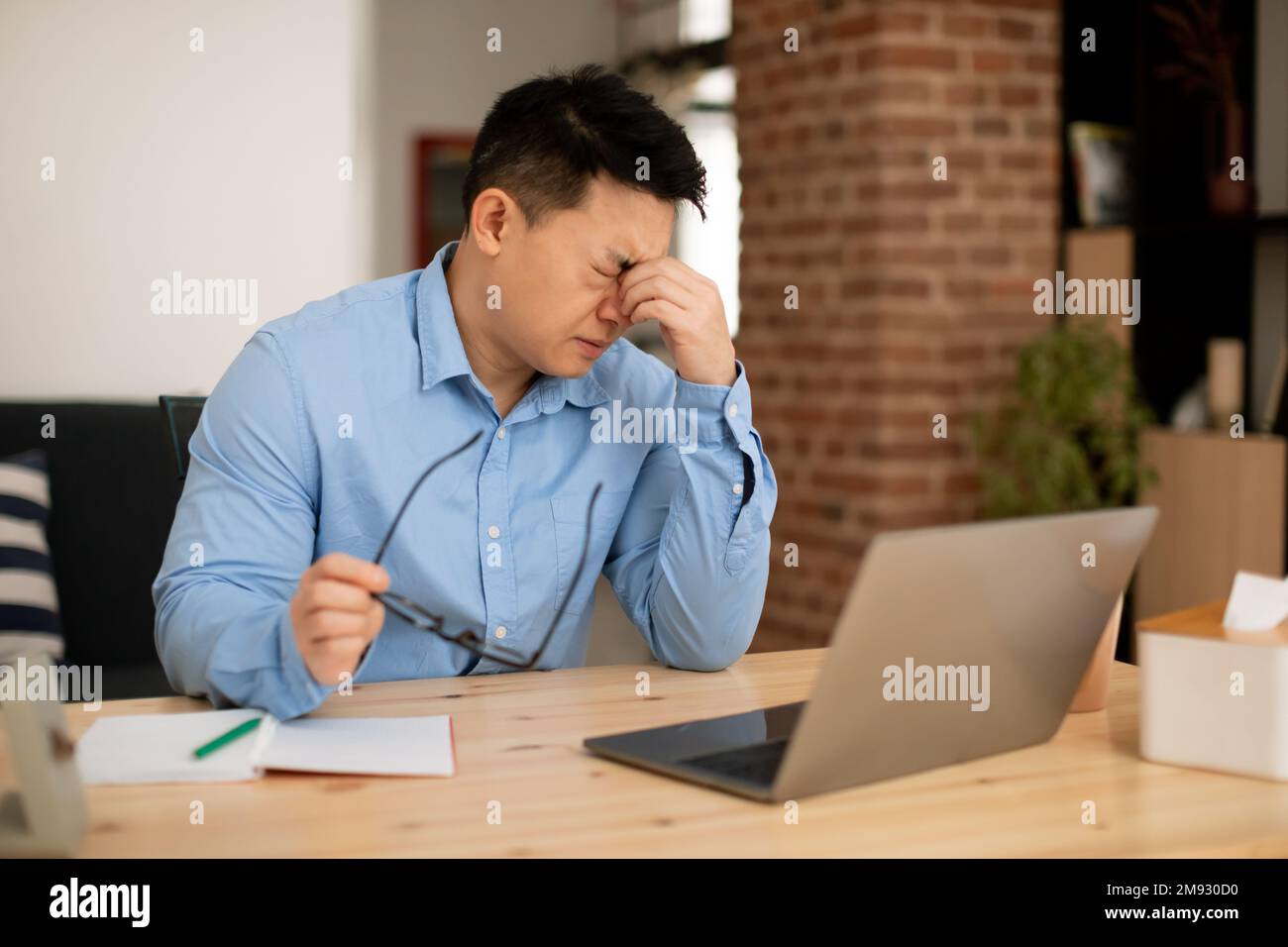 Mature male entrepreneur suffering eyes strain, taking off glasses and massaging nose bridge, feeling tired Stock Photo