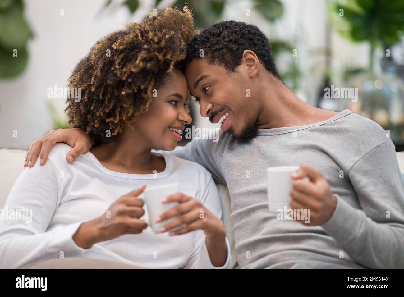 Portrait of sweet african american couple drinking coffee Stock Photo