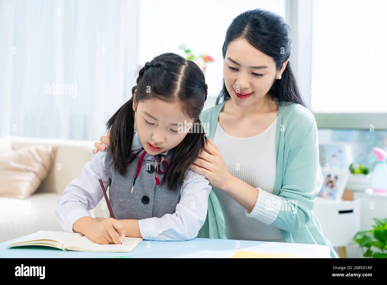 Mother to do homework with your child Stock Photo