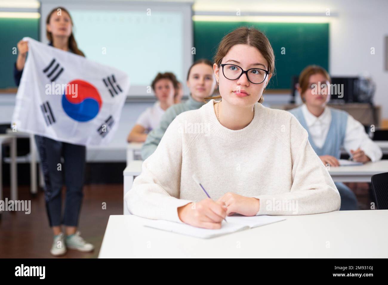 Young girl student diligently studies at school Stock Photo