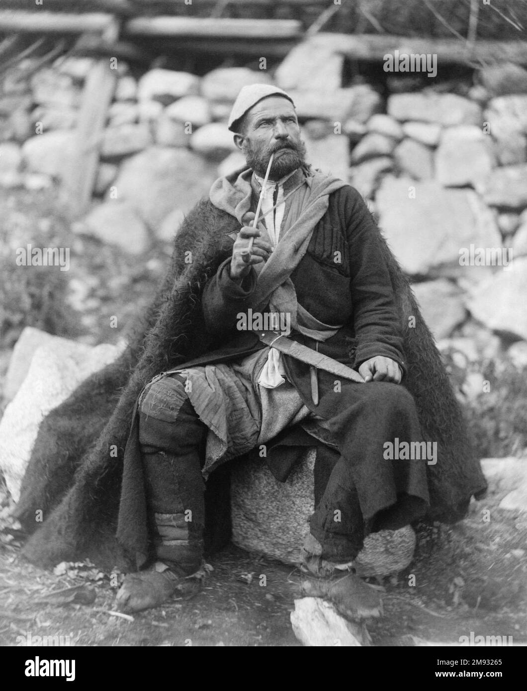 Old peasant with dagger and long smoking pipe, Mestia, Svanetia, Georgia (Republic) ca.  between 1888 and 1900 Stock Photo