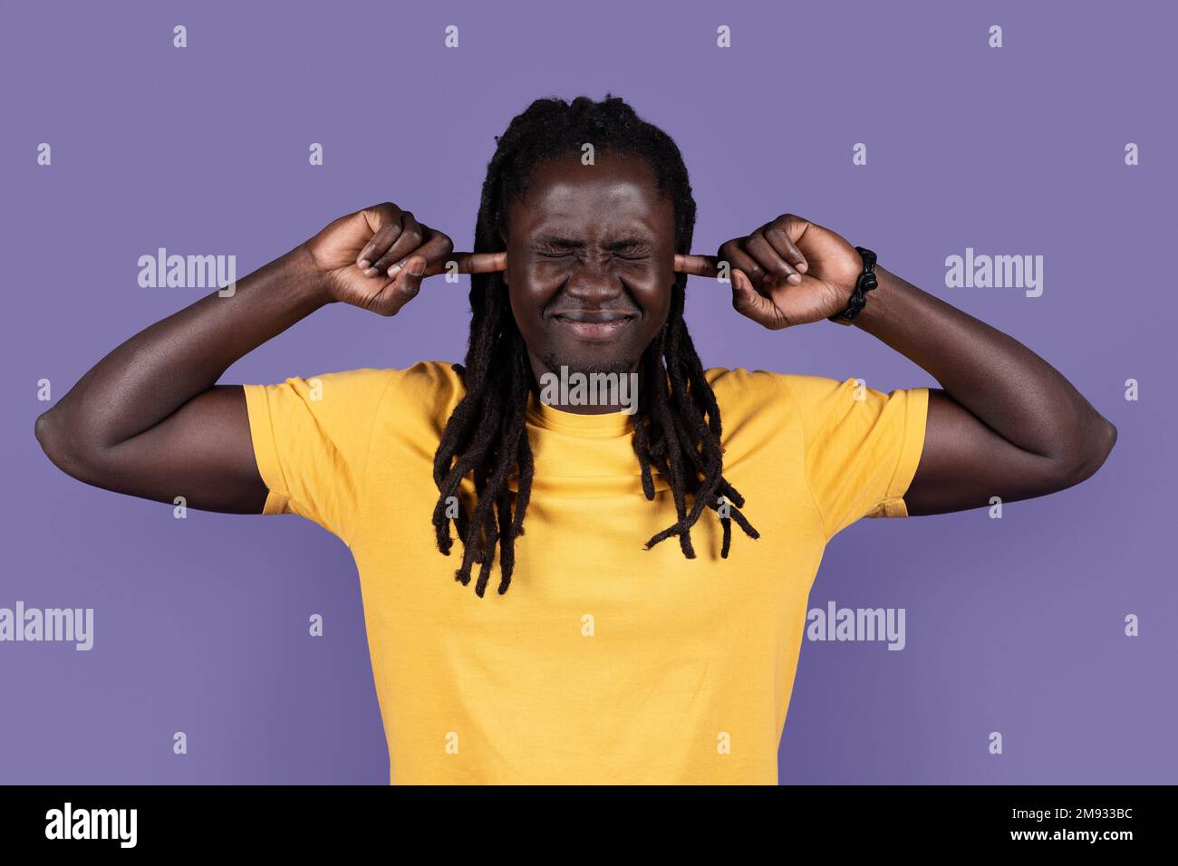 African american young man plugging ears with fingers Stock Photo - Alamy