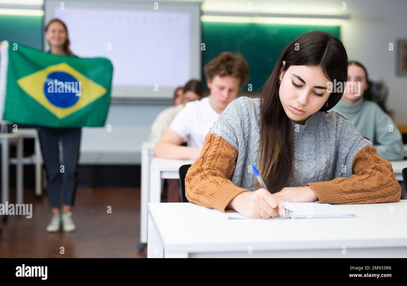 Young girl student diligently studies at school Stock Photo