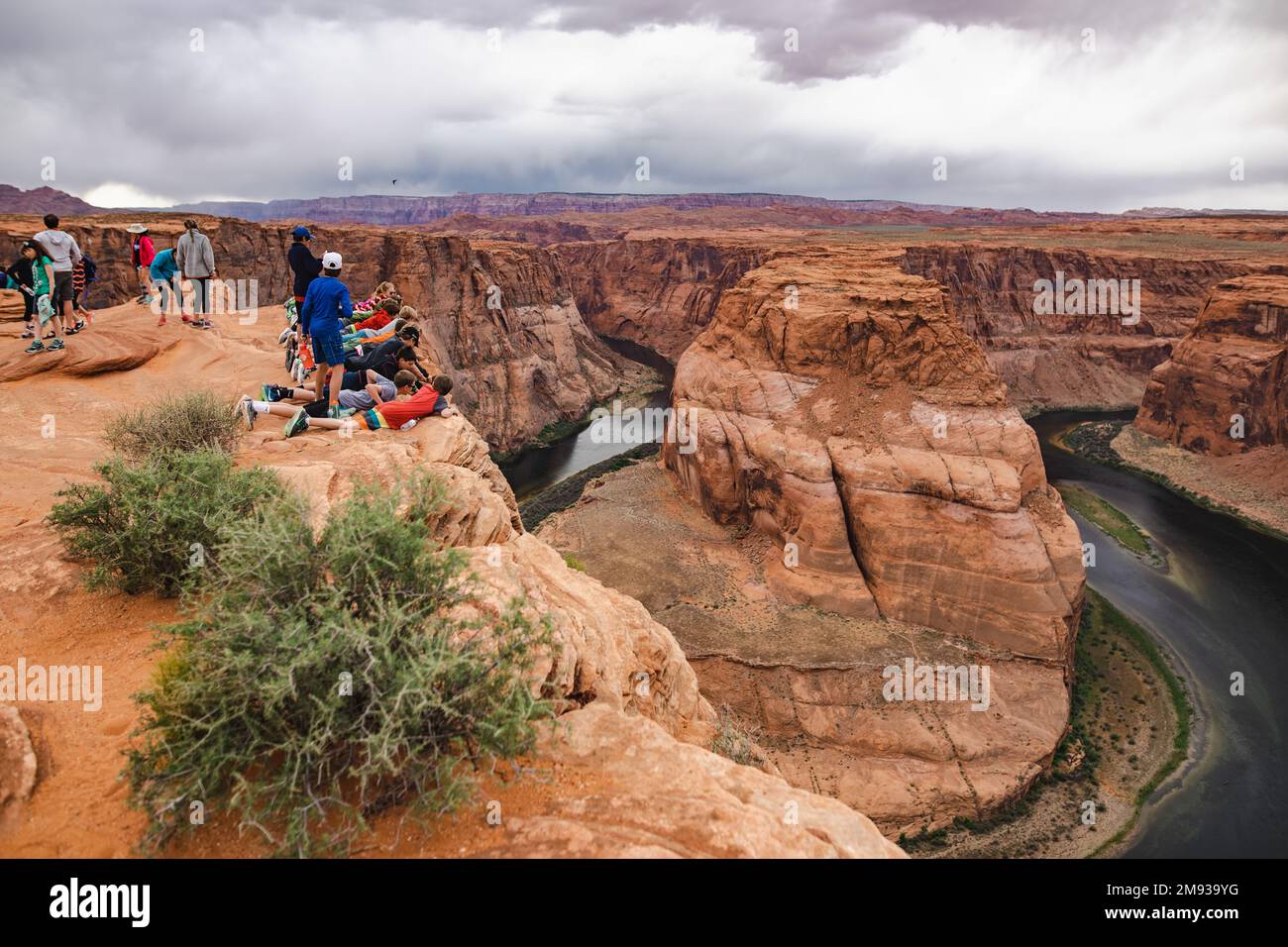 PAGE, ARIZONA, USA - APRIL 2016: Tourist at Horseshoe Bend lookout point on Colorado River in Glen Canyon, part of Grand canyon, Page, Arizona, USA. E Stock Photo