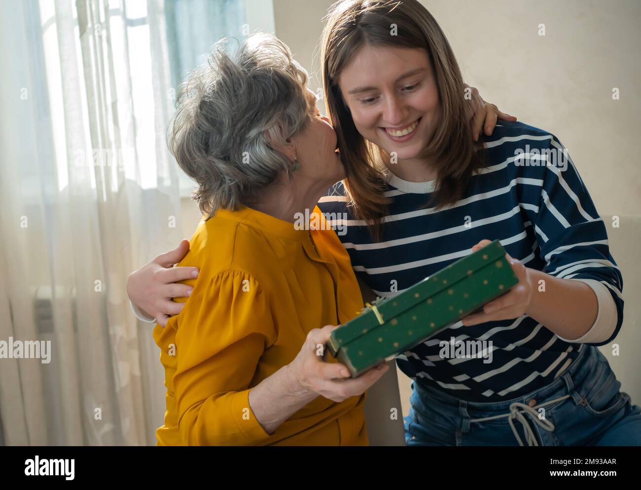 Grandmother and daughter make gifts to each other Stock Photo Alamy