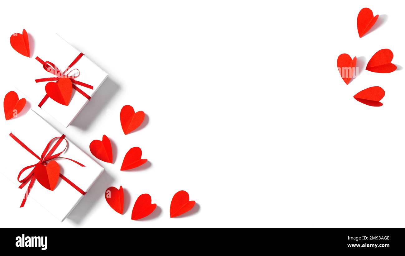 Valentines Day background. Red paper hearts and gift box on white Stock Photo