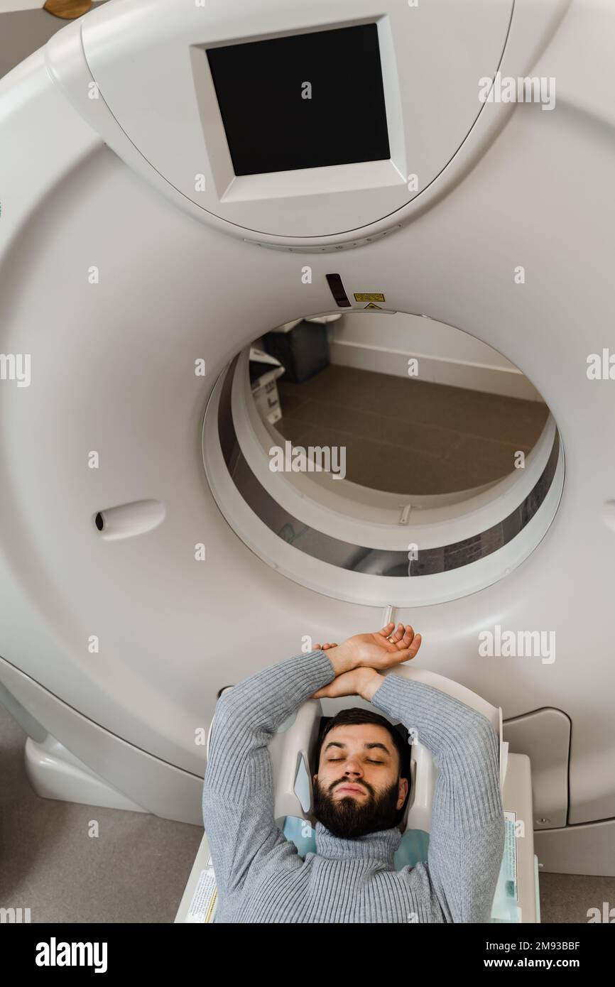 Patient lies on computed tomography bed and scanning lungs for diagnose