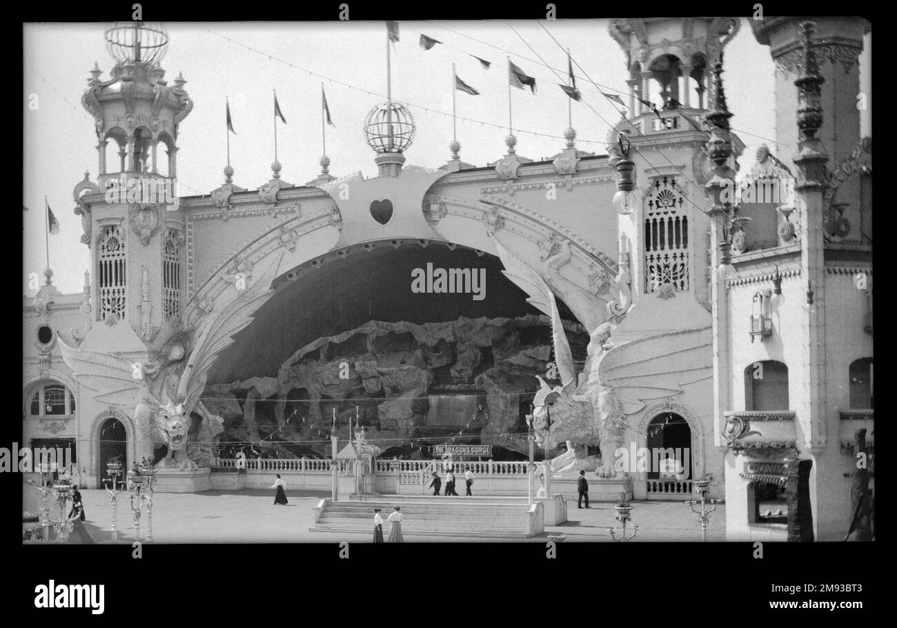 Luna Park, Coney Island Eugene Wemlinger. Luna Park, Coney Island, 1906. Cellulose nitrate negative, 5 3/4 x 3 1/2 in. (14.6 x 8.9 cm).  The Dragon’s Gorge was an enclosed roller coaster, a scenic railroad that brought the passenger on a fantastic trip from the bottom of the sea, through a waterfall, to the North Pole, Africa, the Grand Canyon, and even into Hades, the kingdom of death, over the river Styx. Two dragons framed the entrance, their eyes glowing from globes of green electric light. The ride caught fire in 1944, ultimately leading to the closing of the park two years later.  1906 Stock Photo