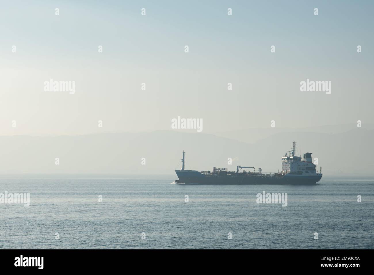 Cargo Ship at Sea , Aerial view of a solo cargo ship on the move in