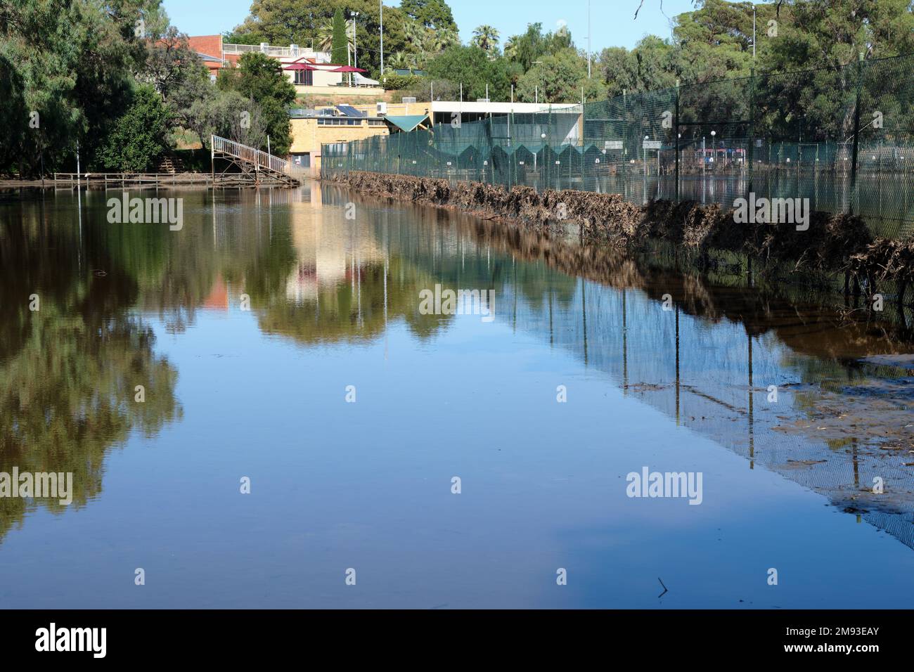 Mildura tennis courts an surrounds covered in flood waters, during the 2022-23 flooding event. Debris can be seen caught in fences and the clubhouse i Stock Photo