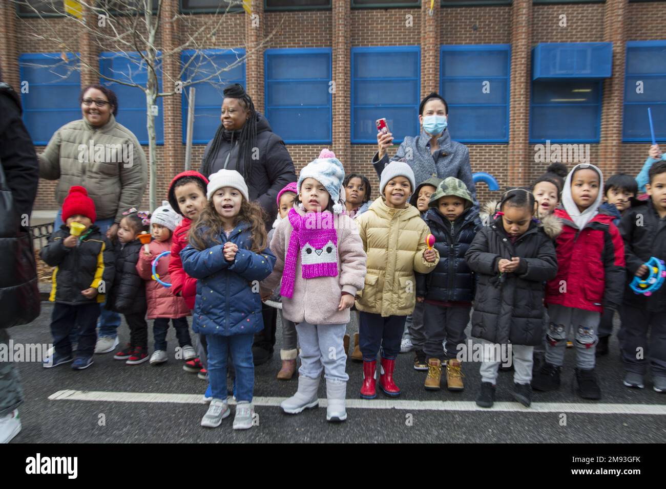 Local school children watch the  2023 Three Kings Day Parade along 3rd Avenue in Spanish Harlem, hosted by El Museo del Barrio, New York’s leading Latino cultural institution. One of the El Museo del Barrio large artistic puppets that lead the parade each year. Stock Photo