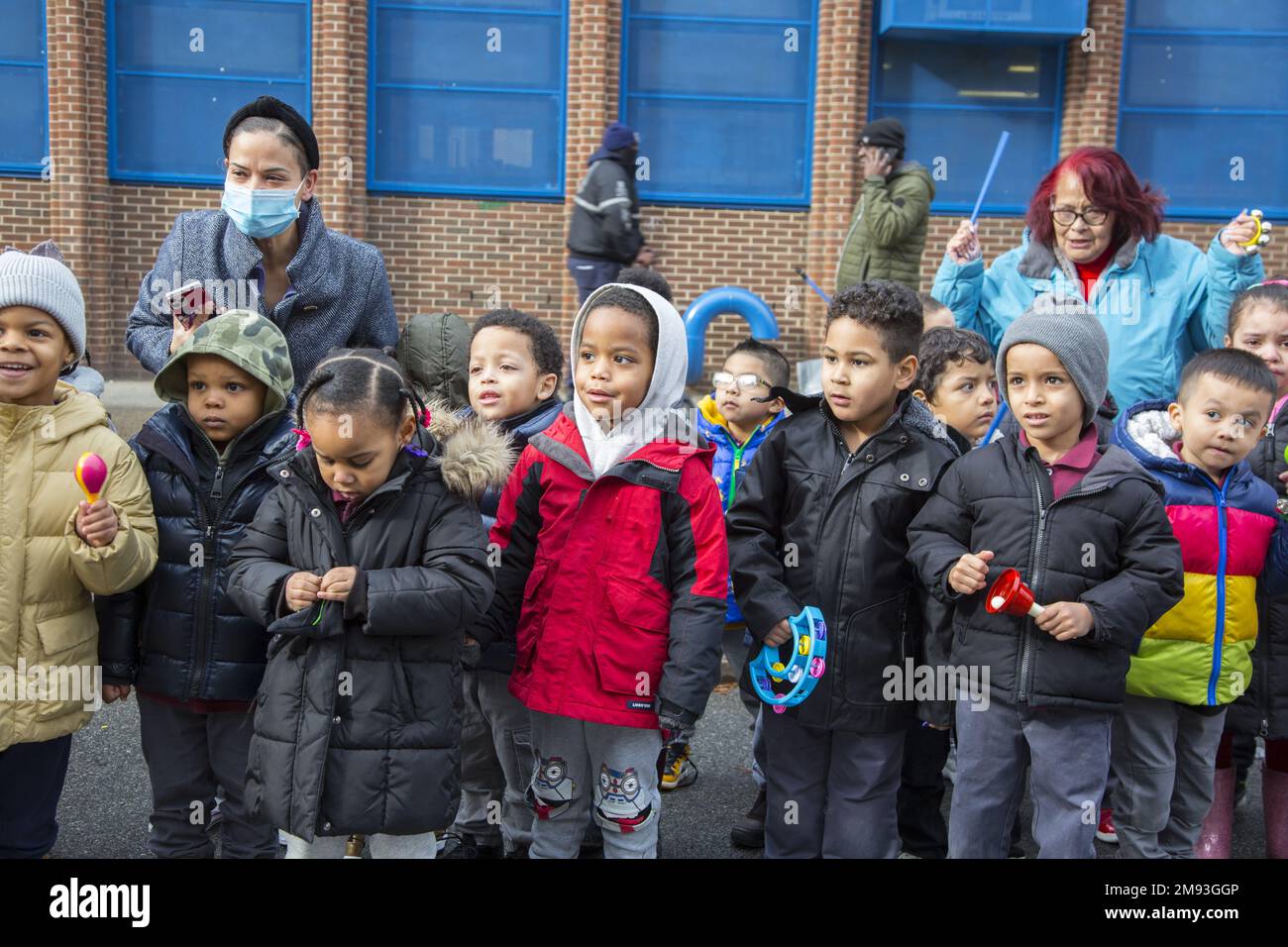 Local school children watch the  2023 Three Kings Day Parade along 3rd Avenue in Spanish Harlem, hosted by El Museo del Barrio, New York’s leading Latino cultural institution. One of the El Museo del Barrio large artistic puppets that lead the parade each year. Stock Photo