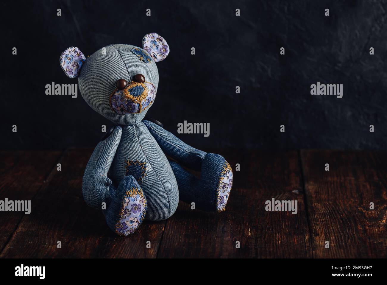 Handmade Teddy Bear Sitting on Wooden Table Stock Photo