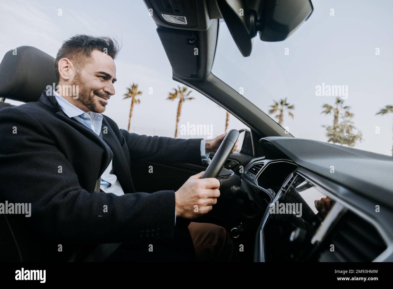 Successful mid adult businessman driving cabriolet car Stock Photo