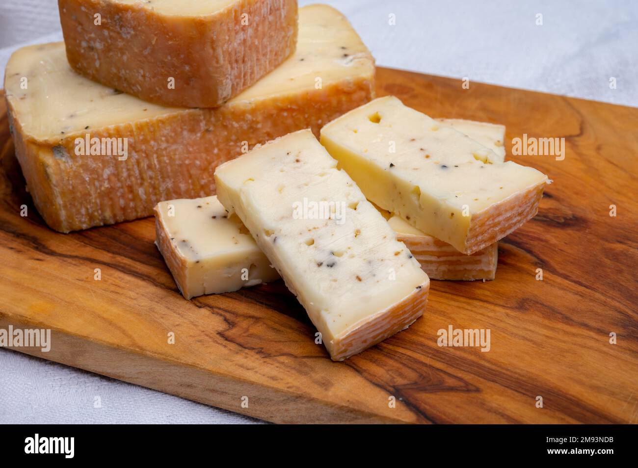 Italian cheese collection, yellow taleggio cheese with black truffles ...