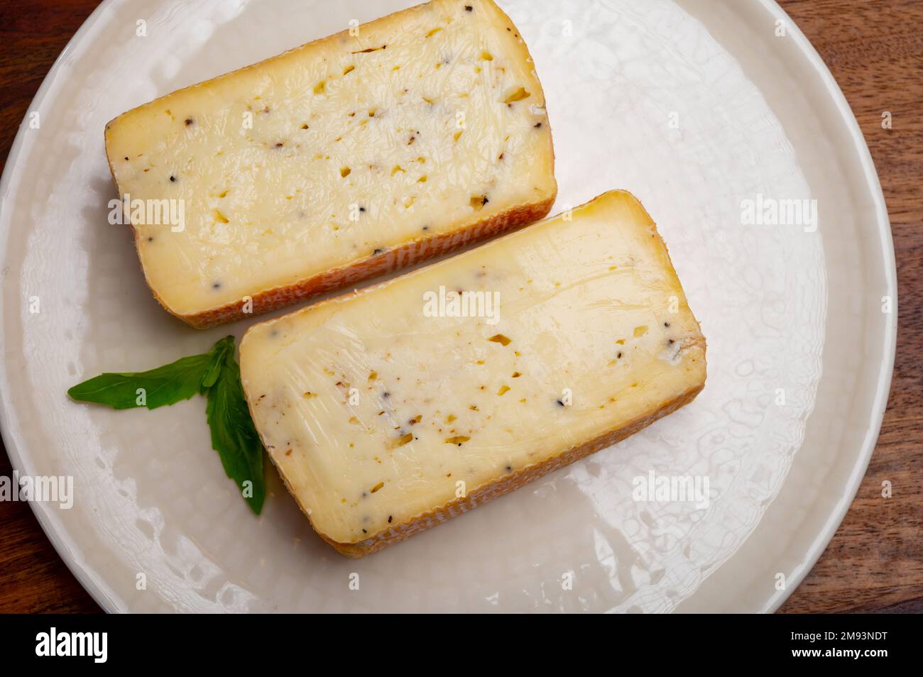 Italian cheese collection, yellow taleggio cheese with black truffles ...