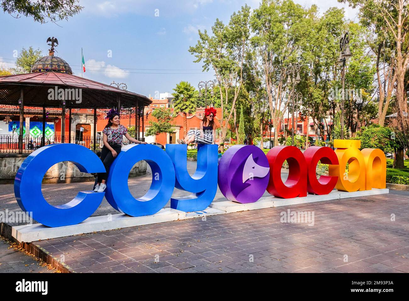 People pose on giant letters spelling out Coyoacan on the Plaza Hidalgo ...